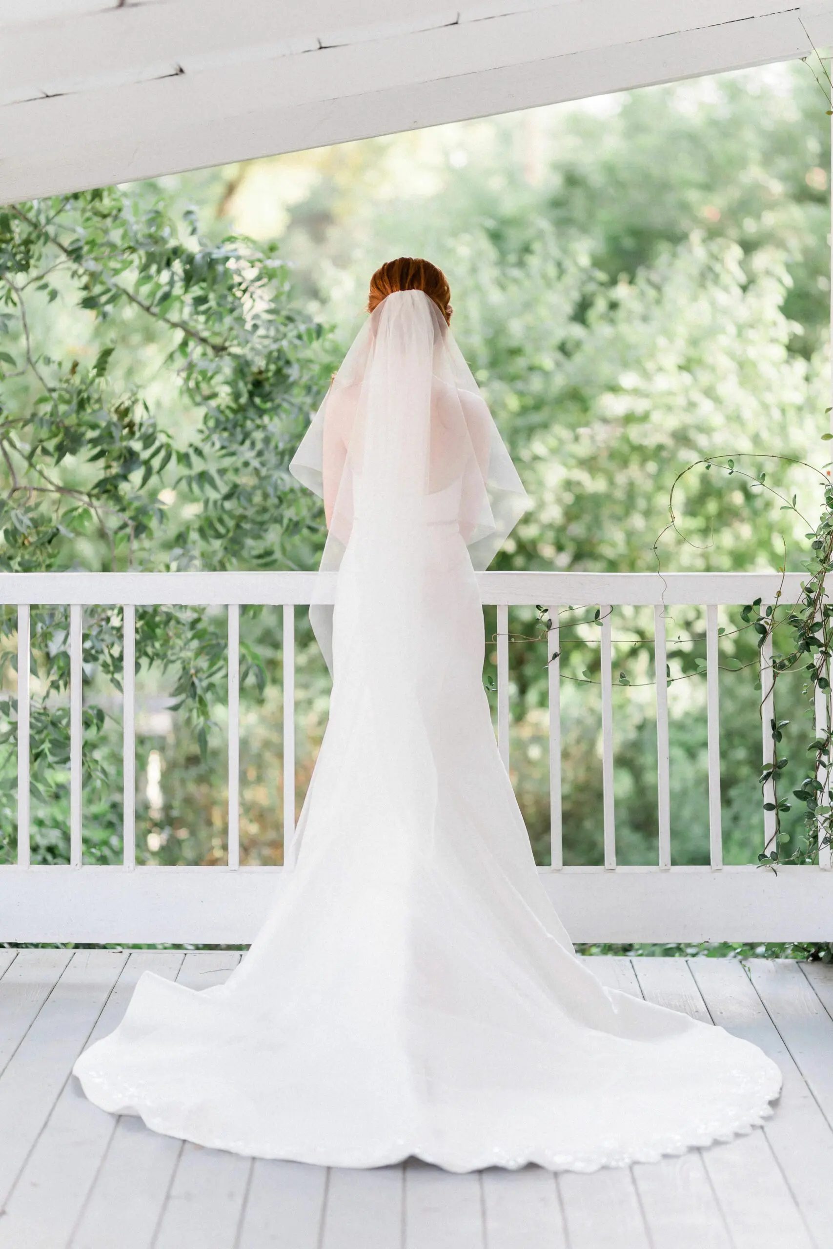 Bride in a wedding dress on a porch at the Stagecoach Inn in Salado, Texas.