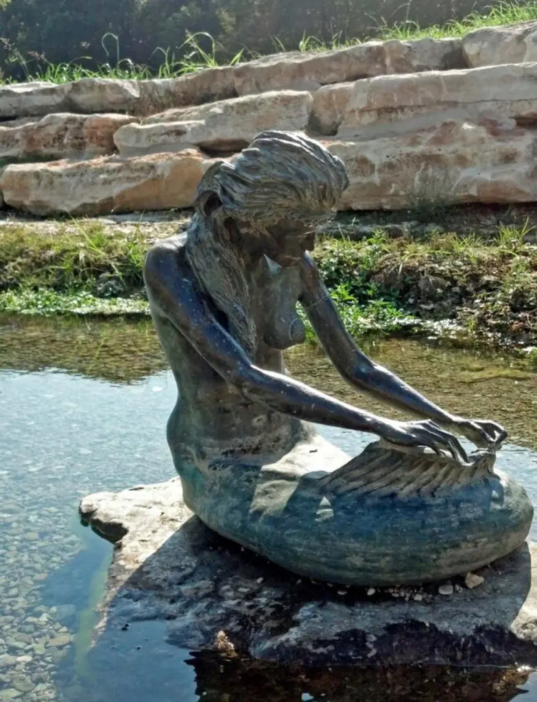 Bronze mermaid statue in Sirena Park, Salado, Texas, inspired by the local legend of Sirena.