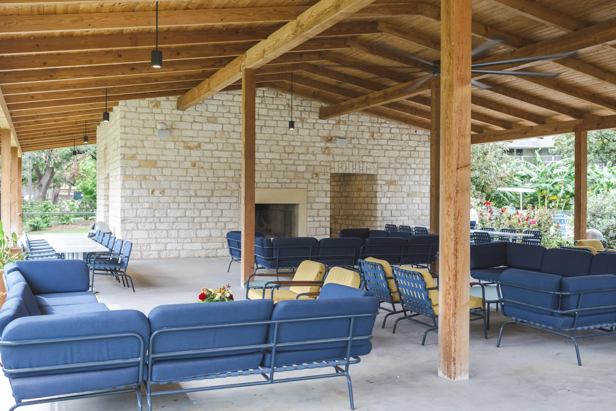 Outdoor pavilion with blue seating and wooden beams at the Stagecoach Inn in Salado, Texas.