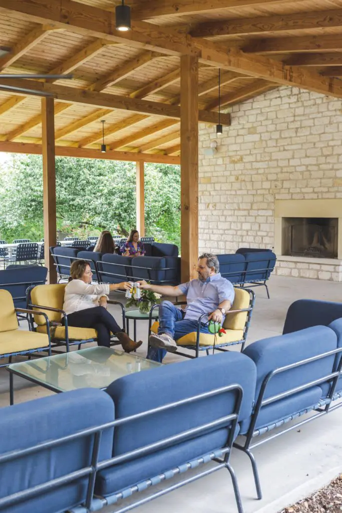 Guests enjoying drinks and conversation in the outdoor lounge area at the Stagecoach Inn in Salado, Texas.