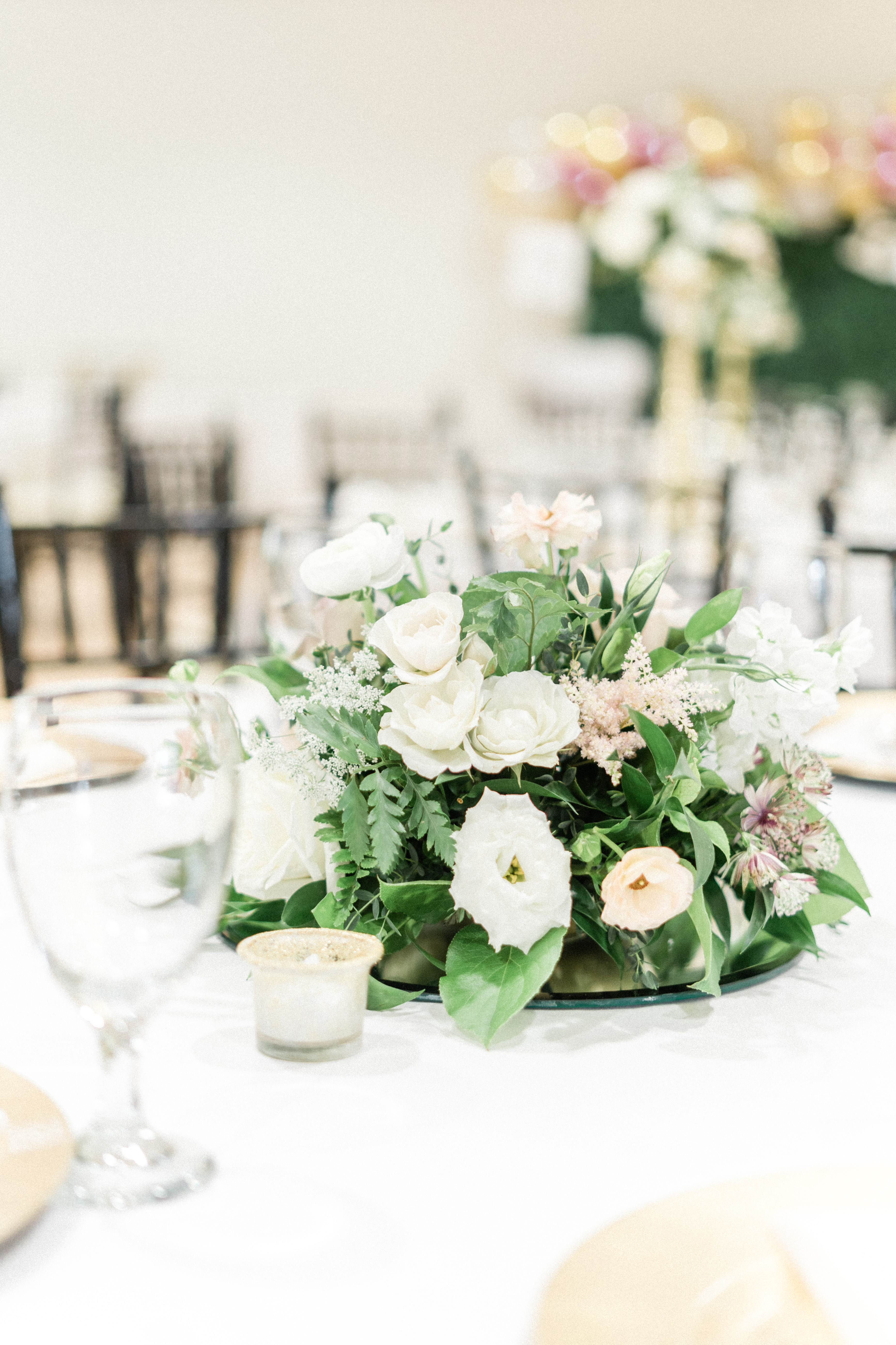 Elegant floral centerpiece at a wedding reception at the Stagecoach Inn in Salado, Texas.