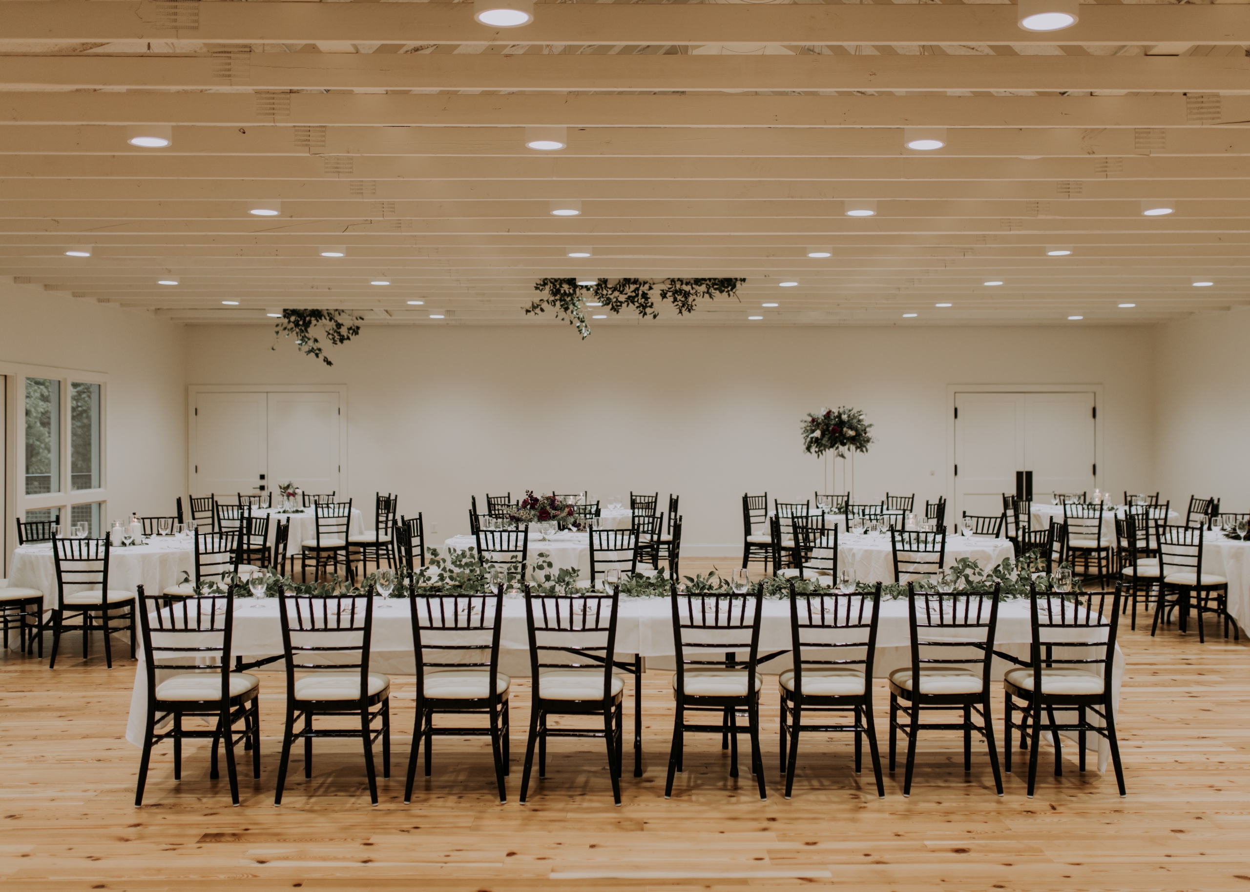 Elegant wedding reception setup with decorated tables by Cone Flower Designs and chairs at the Stagecoach Inn in Salado, Texas. Photography by Jamie Burrow.