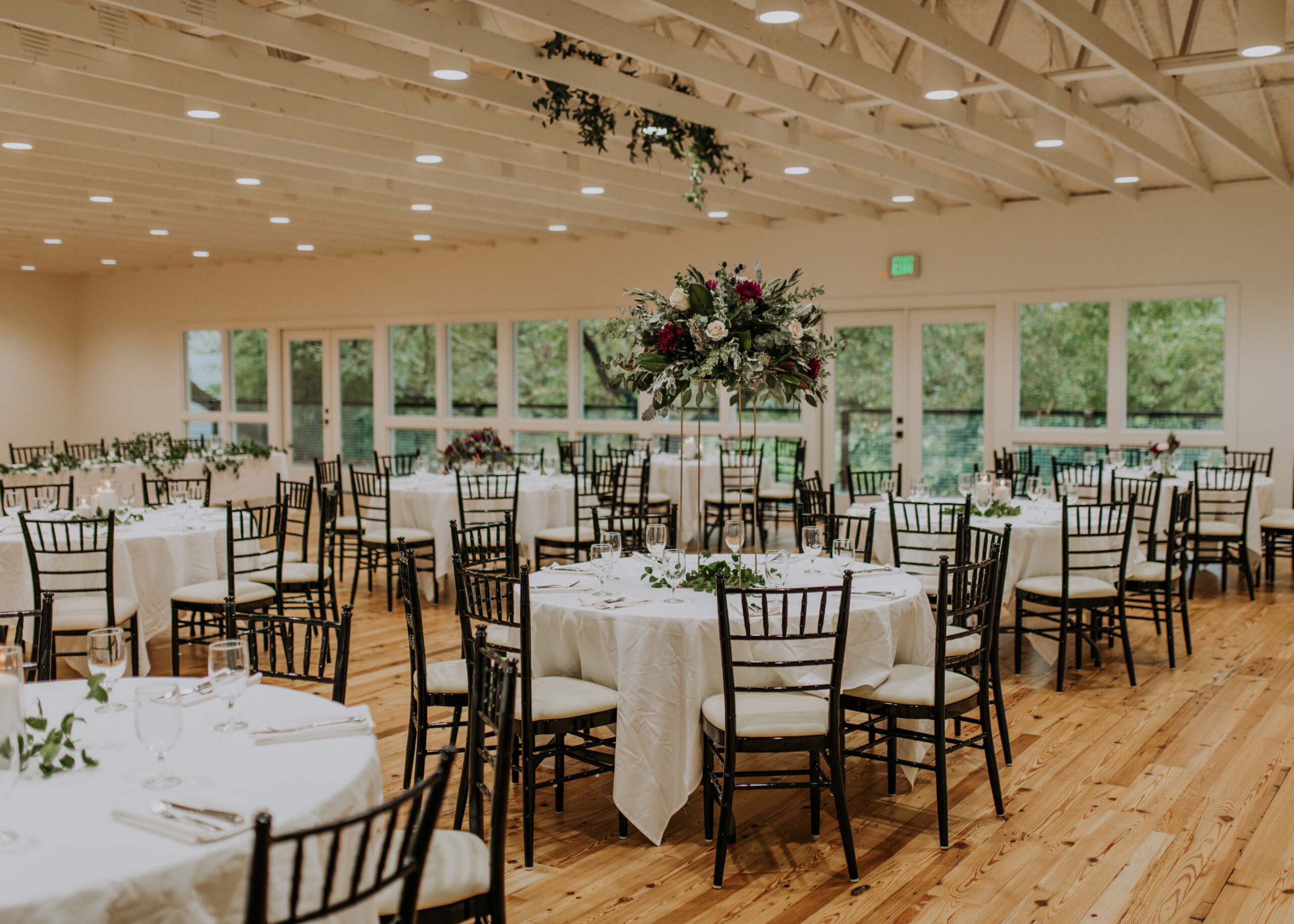 Elegant wedding reception setup with decorated tables by Cone Flower Designs and chairs at the Stagecoach Inn in Salado, Texas. Photography by Jamie Burrow.